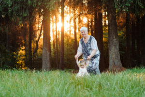 Grandmother and granddaughter walk in the park