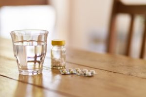 Pills Glass of Water on Table - Medicare Part D Coverage