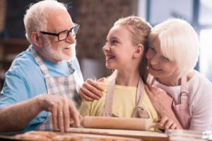 Grandma and Grandpa with Grandaughter Baking - Medicare Advantage