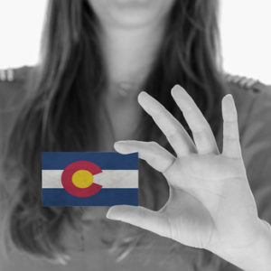 Woman holding Colorado Business Card - Medicare Part D