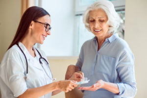 Nurse helping patient with Prescription Medication